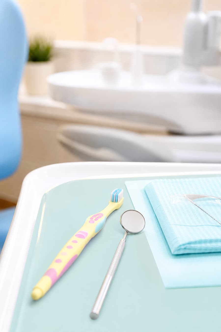 Child-friendly dental care tools on a soft clinical tray